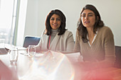 Businesswomen listening in conference room meeting