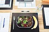 Healthy salad and banana lunch on conference table