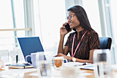 Smiling businesswoman talking on smart phone