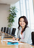Businesswoman working at conference table