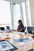 Businesswoman working at laptop in conference room