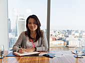 Businesswoman planning in highrise conference room