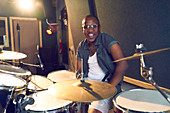 Portrait confident male drummer at drum kit