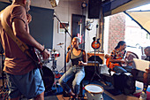 Musicians practicing in garage recording studio