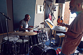 Male musicians with drums and laptop