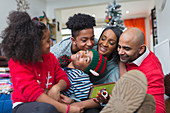 Happy family celebrating Christmas in living room