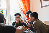 Hungry family eating Christmas cake at table