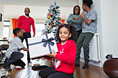 Portrait girl with Christmas gift in living room