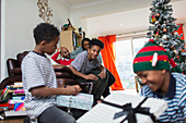 Family opening Christmas gifts in living room