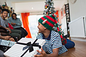 Excited boy opening Christmas gift