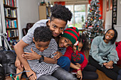 Portrait brothers hugging in Christmas living room