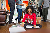 Excited girl opening Christmas gift