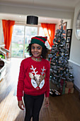 Portrait festive girl in Christmas sweater and hat