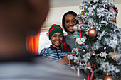 Mother and son decorating Christmas tree