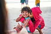 Affectionate brother and sister on beach