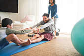 Playful family exercising in living room