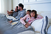 Portrait happy girl relaxing with family on sofa