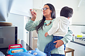 Mother holding son and preparing lunches