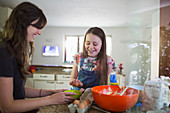 Happy mother and daughter baking