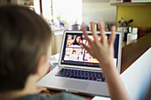 Boy e-learning video conferencing with classmates