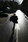 Boy running on wet street