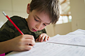 Close up focused boy home schooling