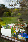 Girl painting in window at home