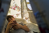 Boy using smart phone inside teepee