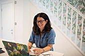 Smiling woman working from home at laptop