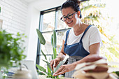 Smiling woman cooking at digital tablet