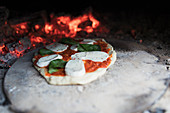 Homemade margherita pizza on stone