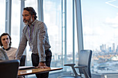 Businessman leading conference room meeting