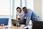 Businessmen working at laptop