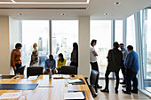 Business people talking at highrise windows