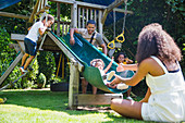 Family playing at play structure