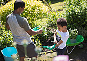 Father and son gardening with gloves
