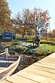 Young couple camping at sunny autumn lakeside