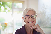Portrait happy senior woman in eyeglasses