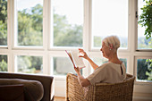 Senior woman relaxing and reading book