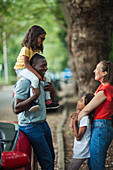 Happy family outside convertible