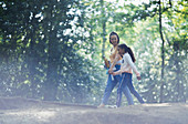 Mother and daughter holding hands hiking