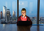 Businesswoman at laptop, London, UK