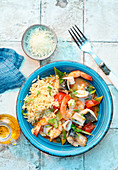 Greek seafood platter with orzo in tomato stock