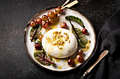 Grilled grapes with burrata, fennel seeds, olive oil and beet leaves