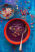 Roasted purple carrot and lentil soup topped with seasalt and edible petals