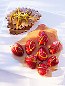 Strawberries with citrus zest and cookies