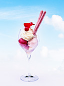 Ice cream sundae with fruit ice cream and whipped cream