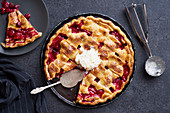 Ccherry pie decorated with lattice and served with ice cream