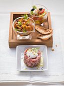 A trio of antipasti – chanterelle mushroom salad, mini caprese, tuna tartarte