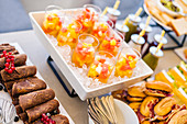 Glasses with refreshing fruit salad made with assorted colorful fruits served on tray with ice